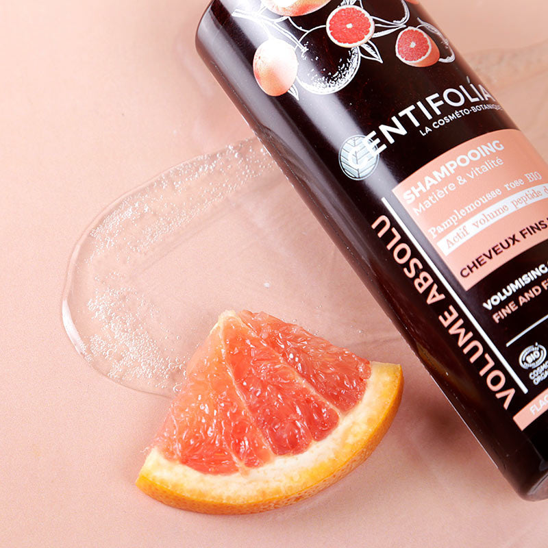 Centifolia Volumising Shampoo (Wholesale) close up with a slice of grapefruit beside it