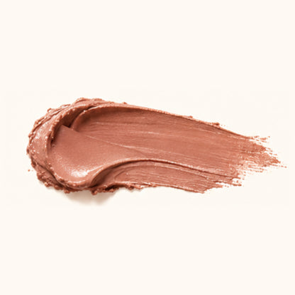 A textured swipe of a warm, shimmery brown cosmetic cream or lipstick on a solid off-white background.